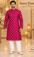Ram Fuchsia adult model wearing the embellished kurta and white polo pajama set in the Saree Duniya showroom.