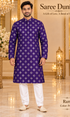 Ram Purple adult model wearing the embellished kurta and white polo pajama set in the Saree Duniya showroom.
