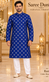 Ram Royal Blue adult model wearing the embellished kurta and white polo pajama set in the Saree Duniya showroom.