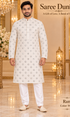 Ram White adult model wearing the embellished kurta and white polo pajama set in the Saree Duniya showroom.