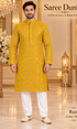 Ram Yellow adult model wearing the embellished kurta and white polo pajama set in the Saree Duniya showroom.