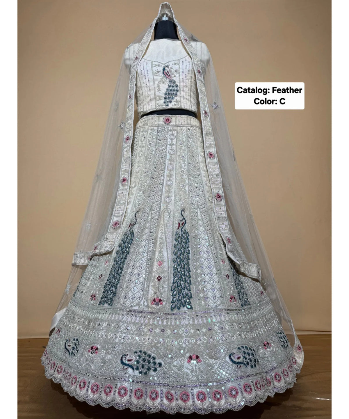 Feathers — C – Ivory; original photograph showing the semi-stitched size 44 lehenga and unstitched blouse fabric with peacock embroidery.