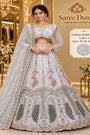 Shubh Labh – Exp 10, Color A – Ice Blue, sizes 38, 40, 42 and 44. Saree Duniya model wearing the embellished lehenga with sheer long sleeves, arched blouse hem and peacock panels.