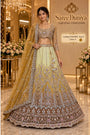 PAD11001 - Exp 11, Color A, size 42 - model wearing the mustard and lemon-to-brown ombre embellished lehenga in the Saree Duniya showroom.